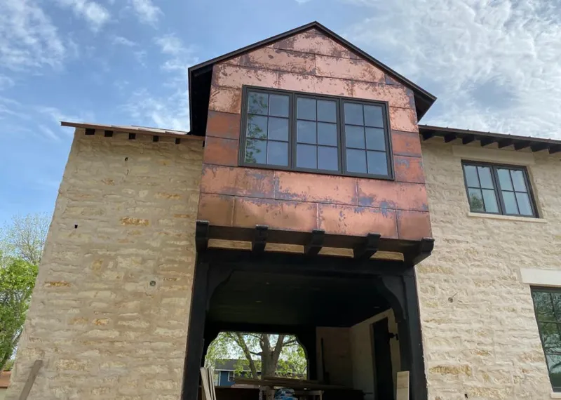 Copper metal panel facade on a stone building for Metal Roof Coating in Waseca