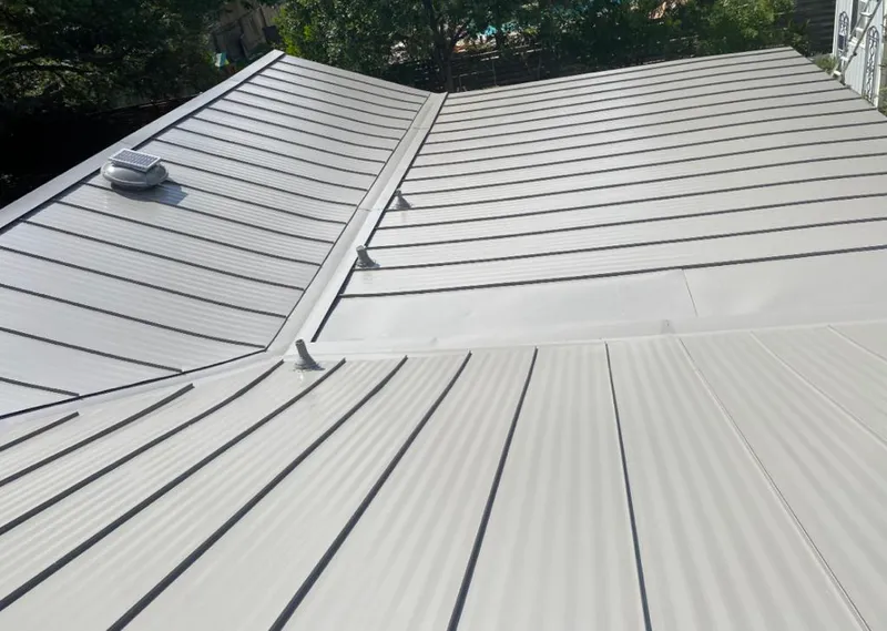 Solar attic fan installed on a metal roof for Roof Ventilation in Waseca
